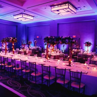 Decorated banquet hall with flowers, rectangle table, chiavari c