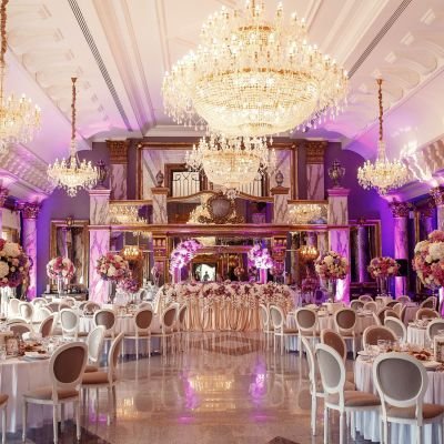 Luxurious dinner hall with large crystal chandeliers hanging fro